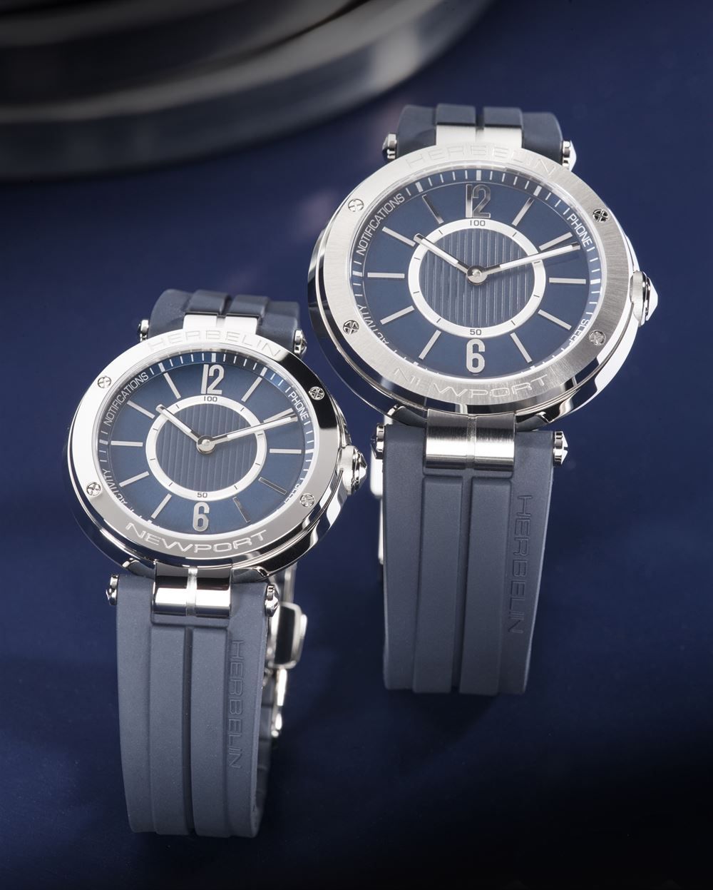 Ein paar Uhren liegen nebeneinander auf einer blauen Fläche