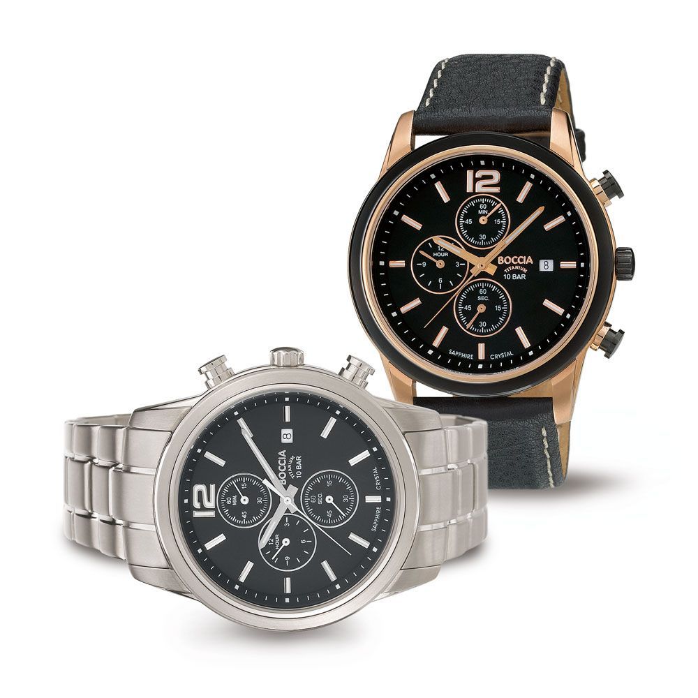 Zwei Uhren liegen nebeneinander auf einem weißen Hintergrund