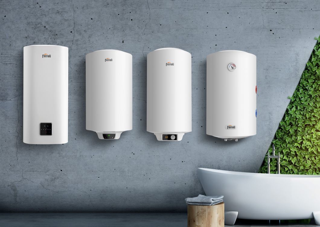 Tres calentadores de agua blancos están colgados en una pared en un baño al lado de una bañera.