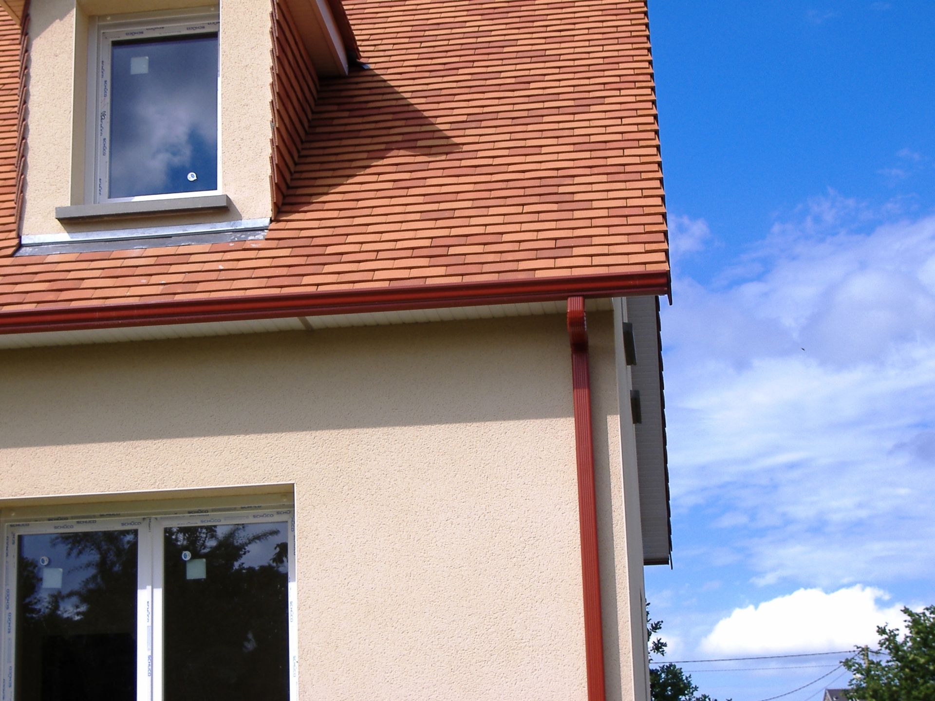 Une gouttière rouge sur une maison