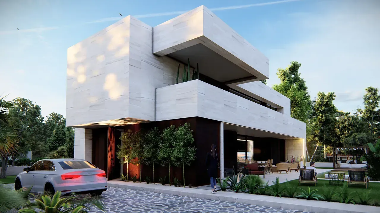 Un coche blanco está aparcado delante de una gran casa blanca.