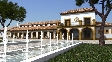 Patio de estilo español con fuente blanca, arcos amarillos y edificio con azulejos bajo un cielo azul.