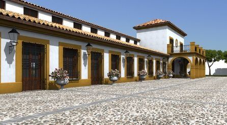 Patio de estilo español con edificios de estuco blanco, techo de tejas, puertas de madera y suelo empedrado bajo un cielo despejado.