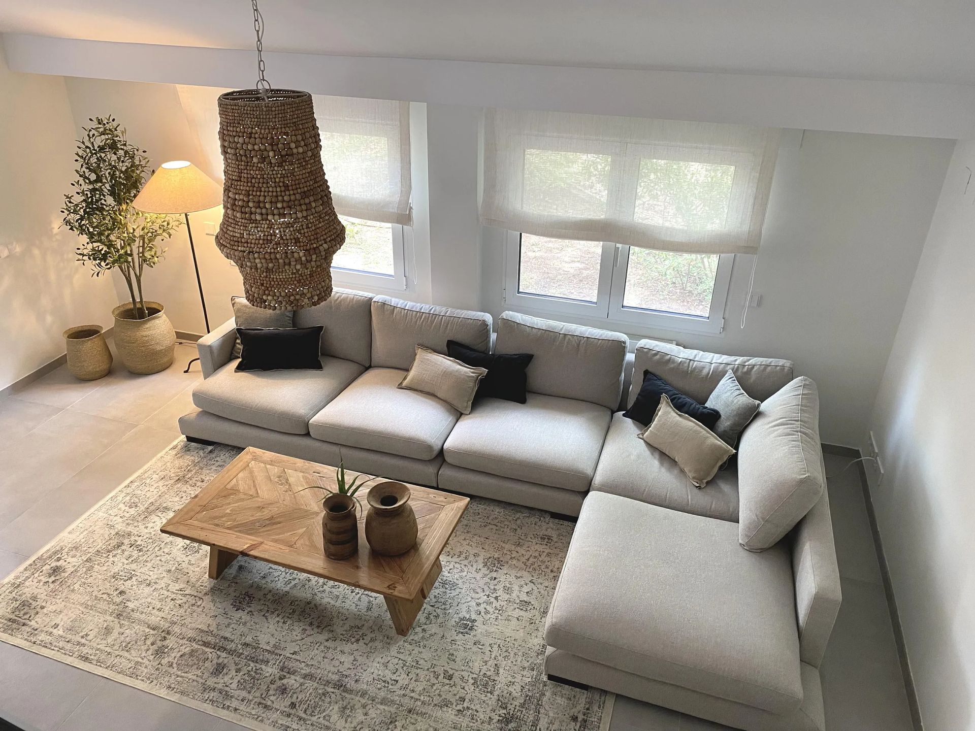 Una sala de estar con un gran sofá seccional y una mesa de café.