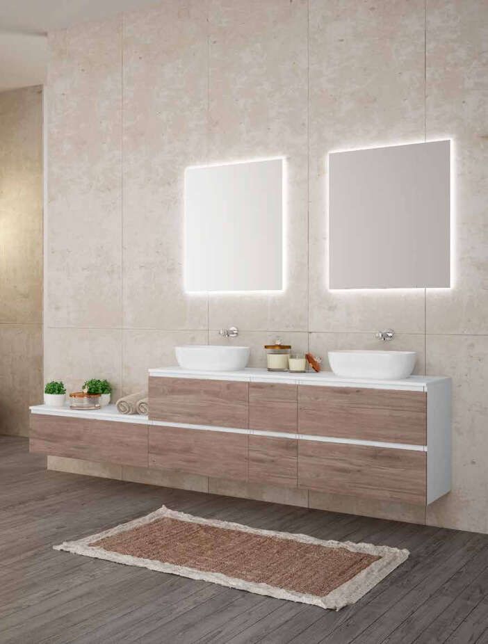 Un baño con dos lavabos y dos espejos.