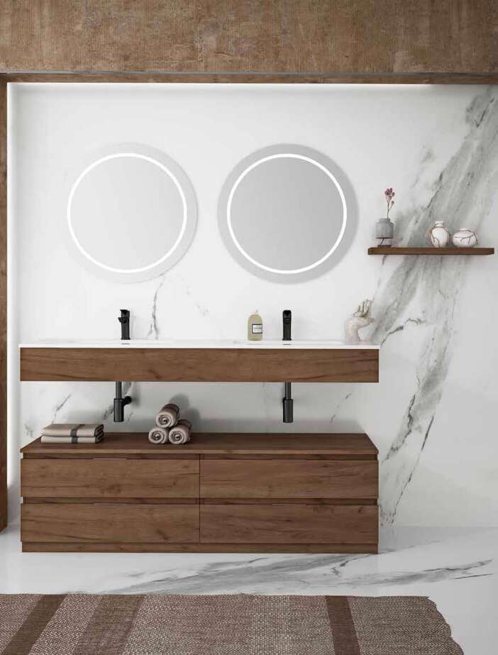 Un baño con dos lavabos y dos espejos.