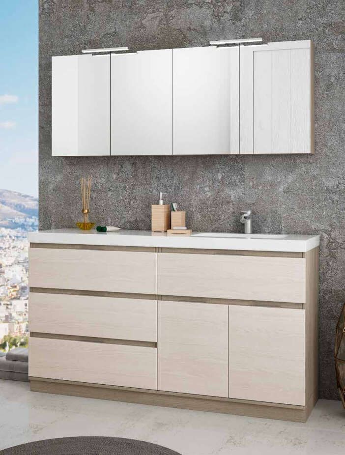 Un tocador de baño con lavabo, espejo y cajones.