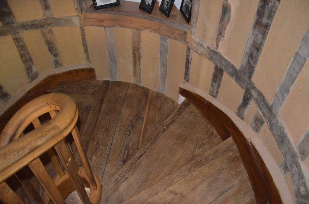 Colombage ancien sur mur arrondi dans un escalier en colimaçon