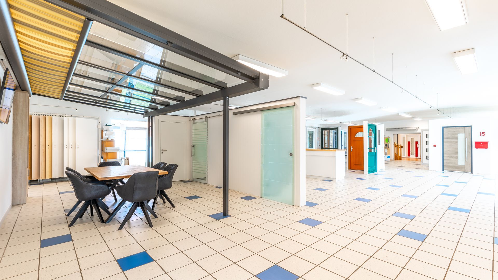 Ein großer Raum mit einem Tisch und Stühlen darin.