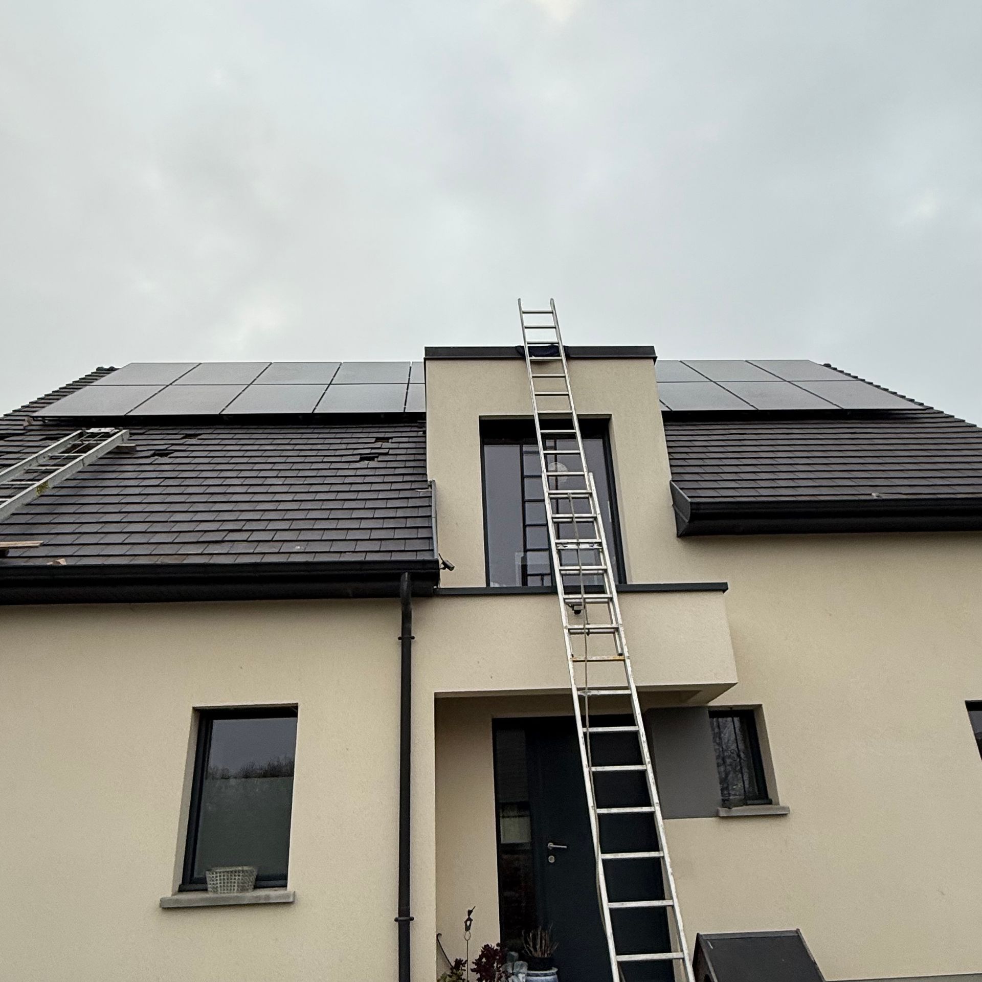Échelle devant une fenêtre pour aller sur le toit