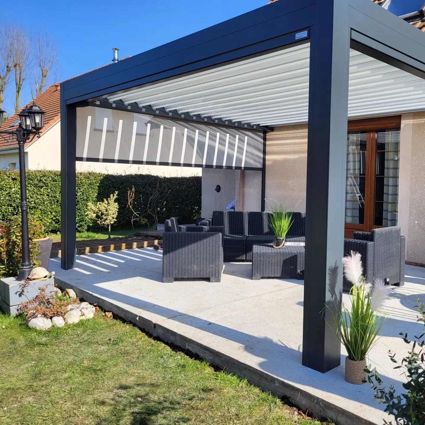 Terrasse d'une habitation en plein soleil sous une pergola.