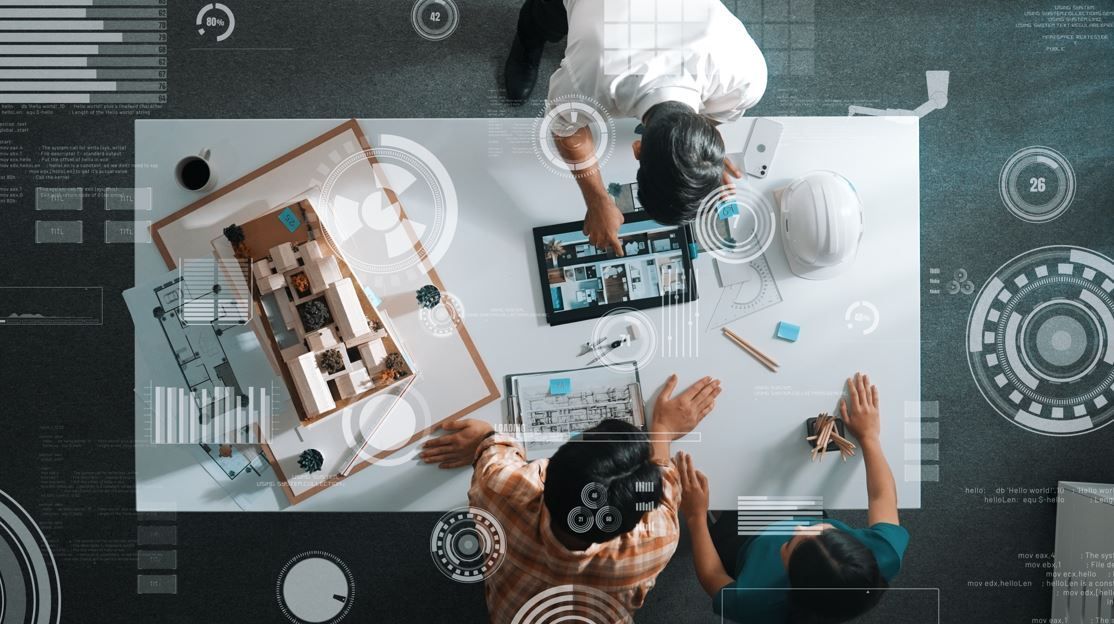 Arquitectos colaborando alrededor de una mesa con una maqueta, una tableta y una superposición digital.