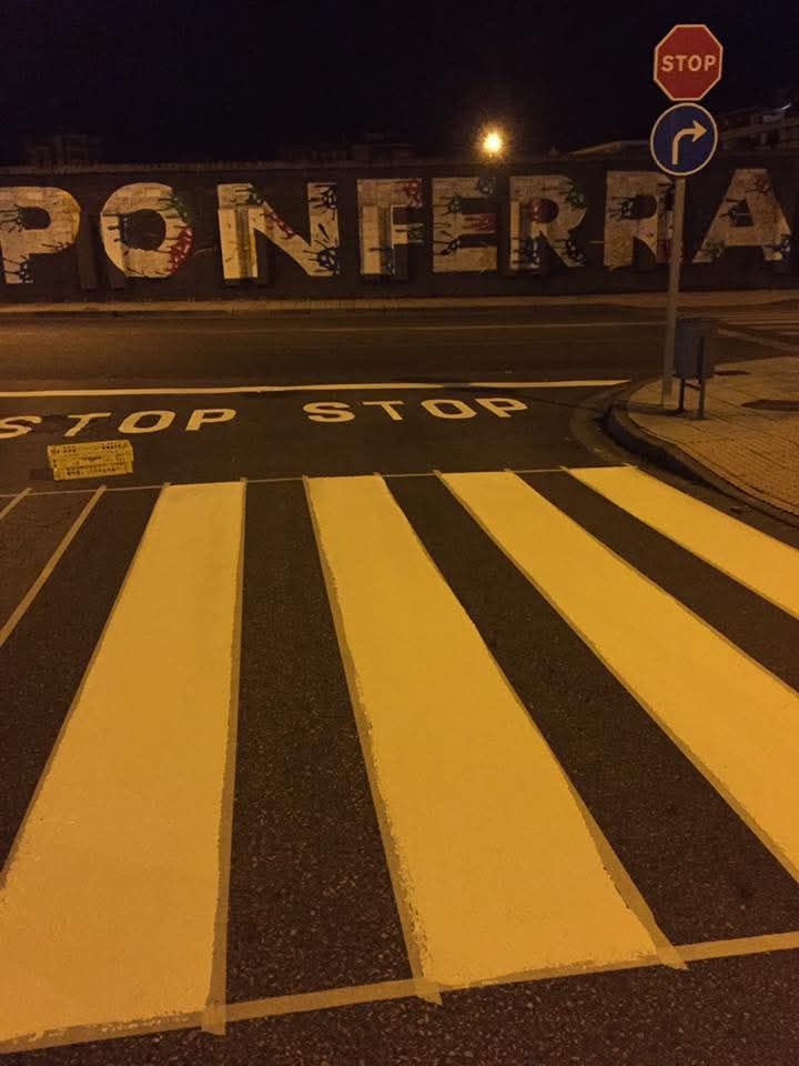 Un paso de peatones con una señal de stop al fondo