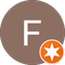 Brauner Kreis mit weißem „F“ und ein kleinerer orangefarbener Kreis mit einem weißen Stern.