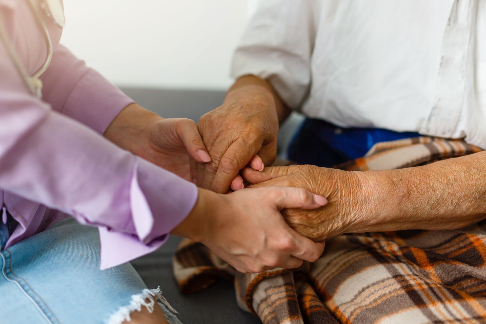 Femme tenant les mains d'une personne âgée