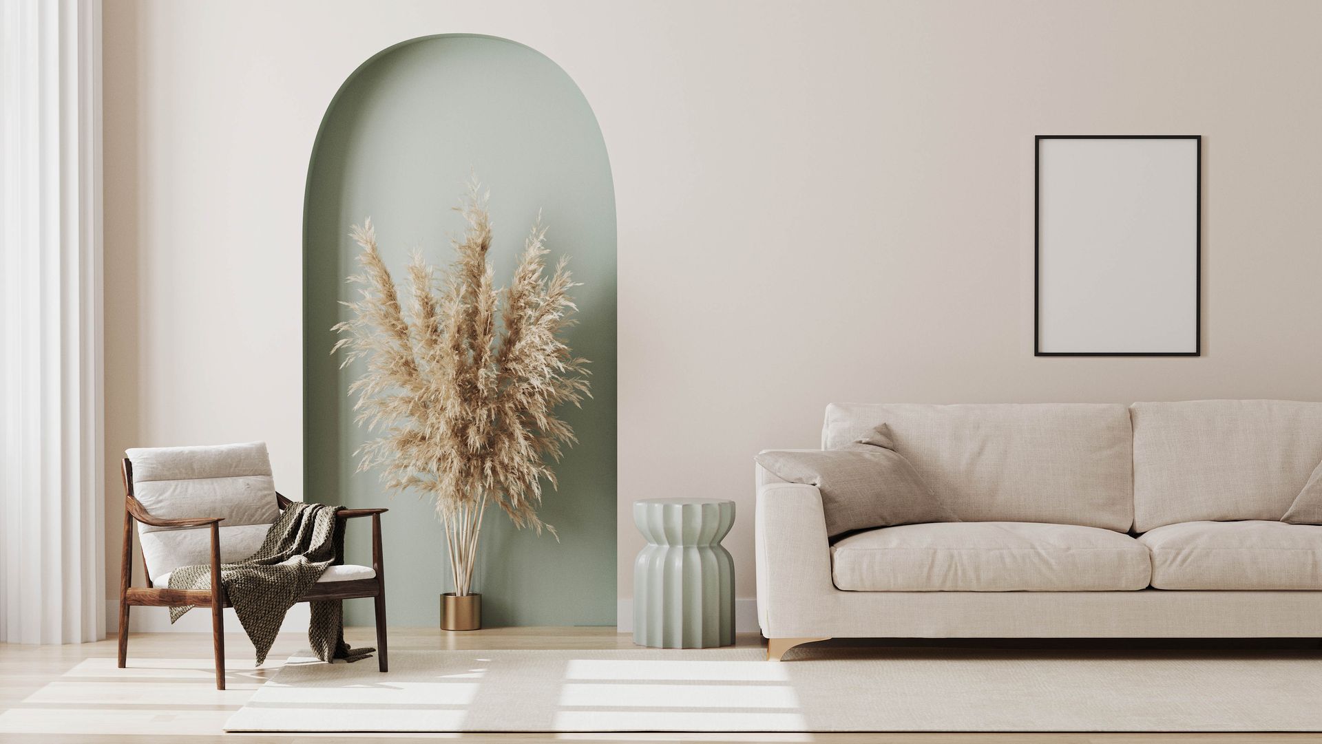 Salon minimaliste avec canapé beige, alcôve cintrée, herbes de la pampa séchées et une estampe encadrée.