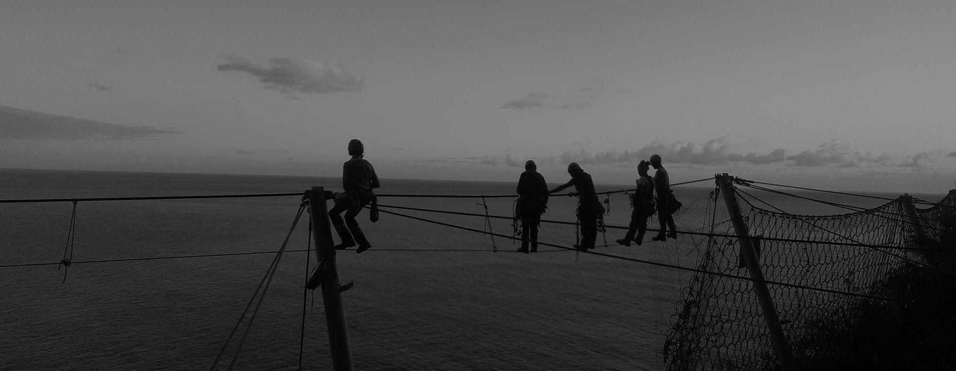Équipe de cordistes suspendue en bord de mer