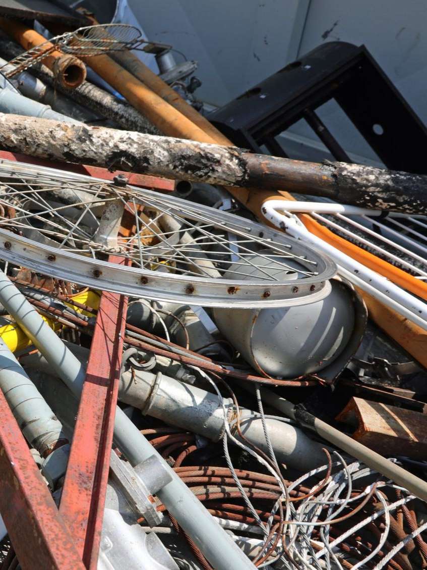 Tas de ferraille comprenant une roue de vélo.