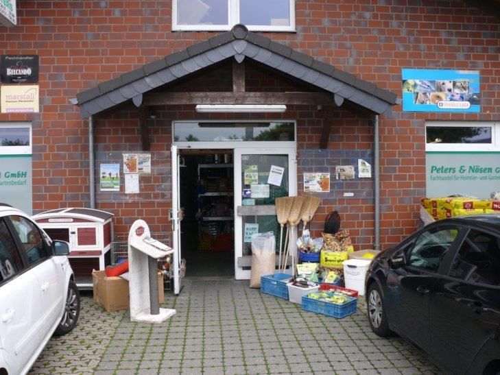 Eine Ladenfront mit davor geparkten Autos