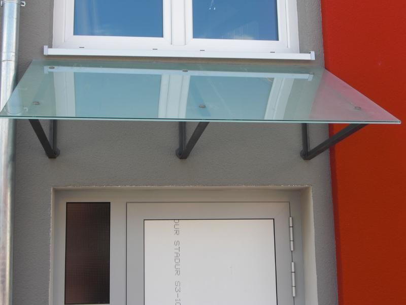 eine weiße Tür mit einem Glasdach darüber