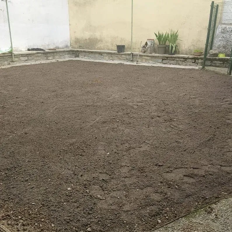 Hay un gran montón de tierra en el medio de un patio.