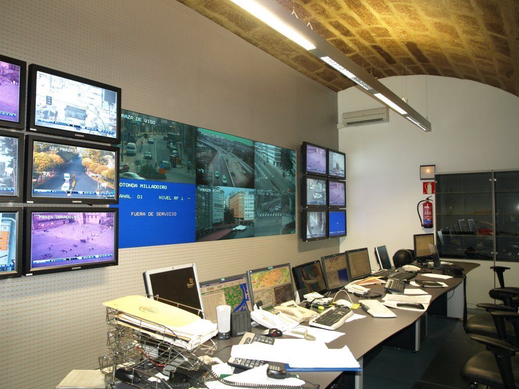 Una habitación con muchos monitores en la pared