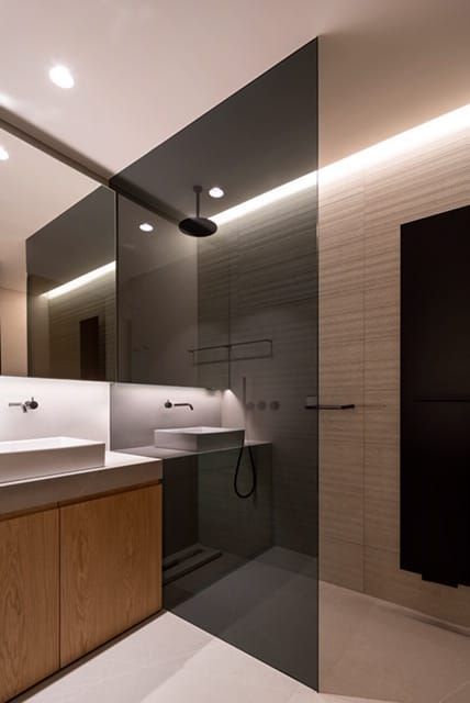 Un baño con ducha a ras de suelo y lavabo.