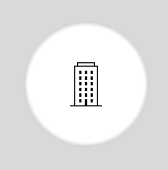 Un icono en blanco y negro de un edificio en un círculo sobre un fondo gris.