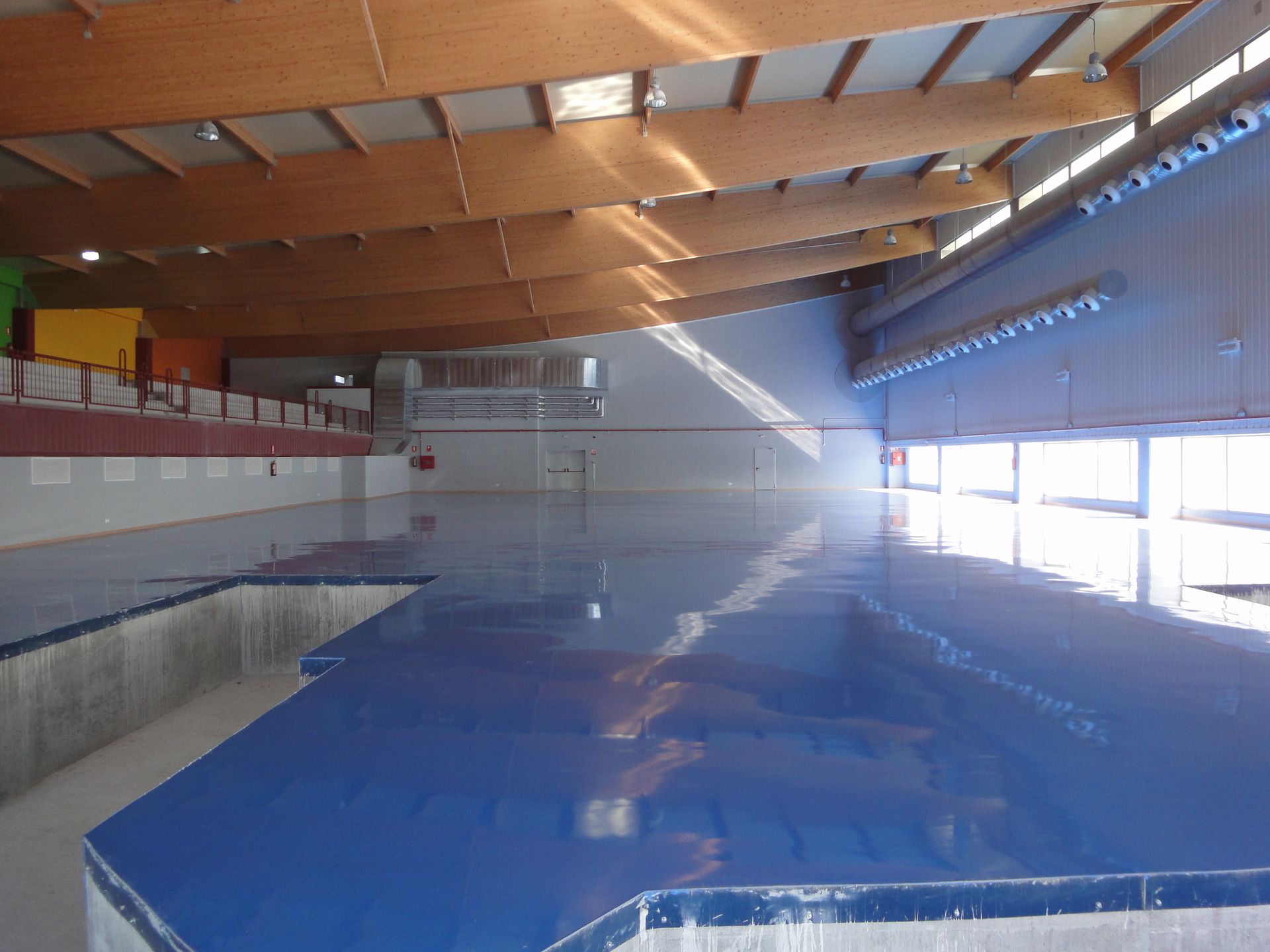 Una gran piscina cubierta con techo de madera.