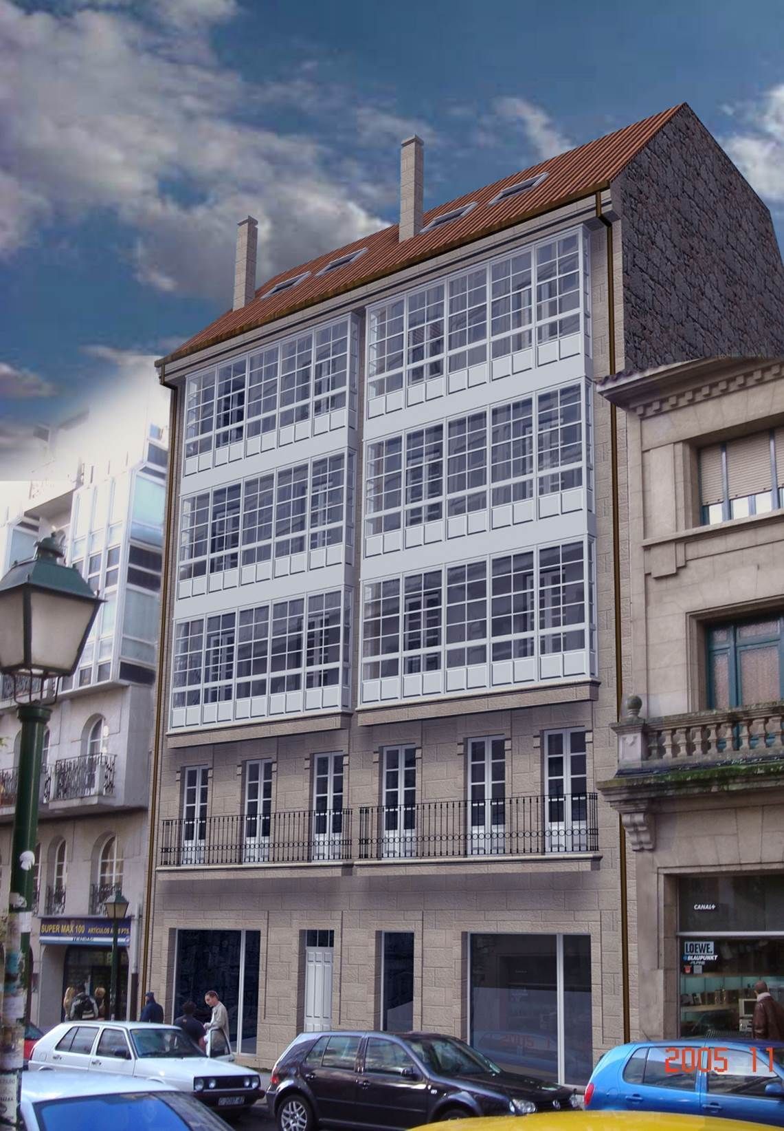 Un edificio con muchas ventanas y coches aparcados delante.