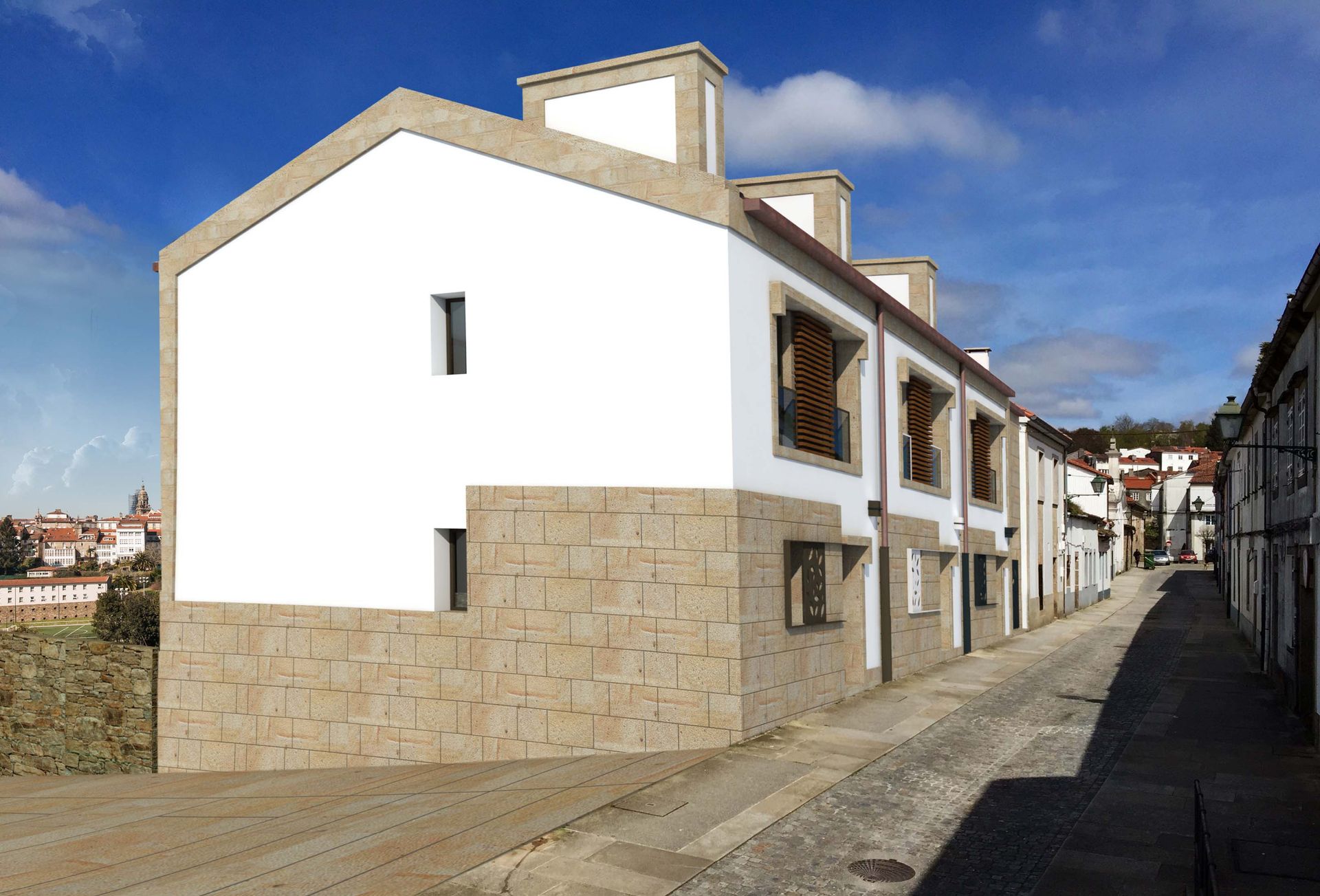 Un edificio blanco con fachada de piedra está al lado de un camino de tierra.