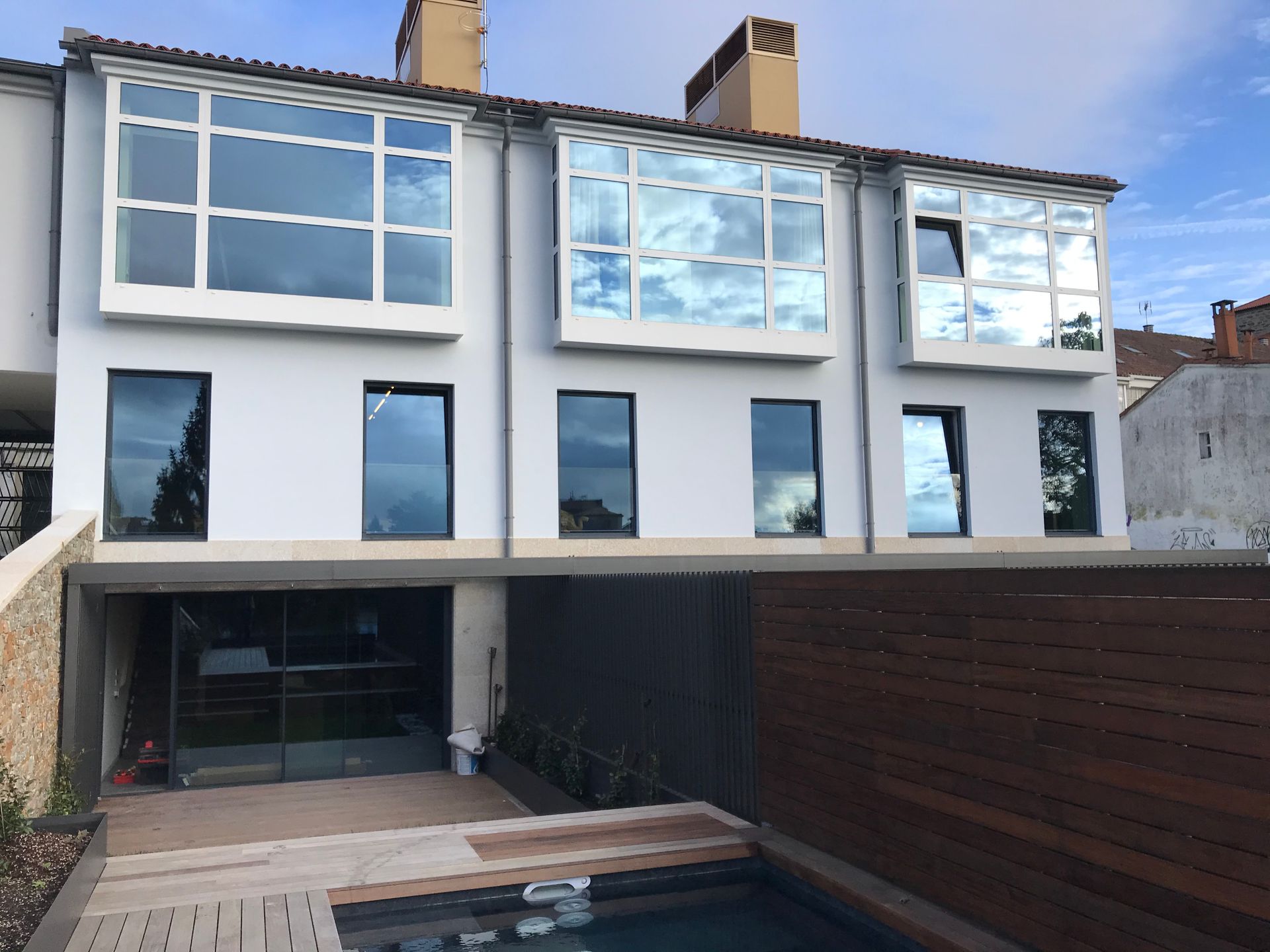 Un gran edificio blanco con una piscina enfrente.
