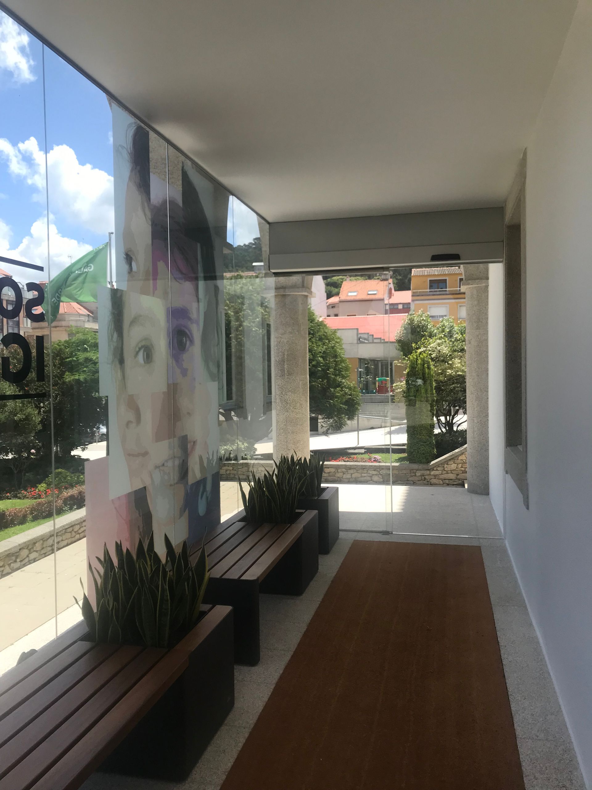 El reflejo del rostro de una mujer está en una pared de cristal.