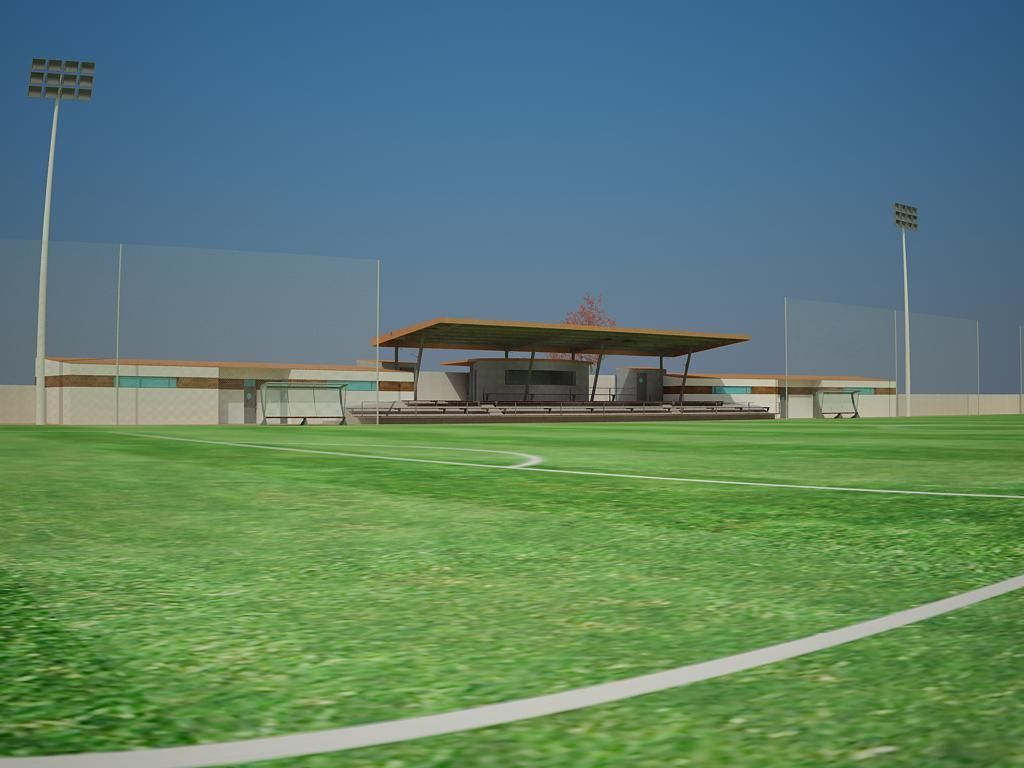 Un campo de fútbol con un estadio al fondo