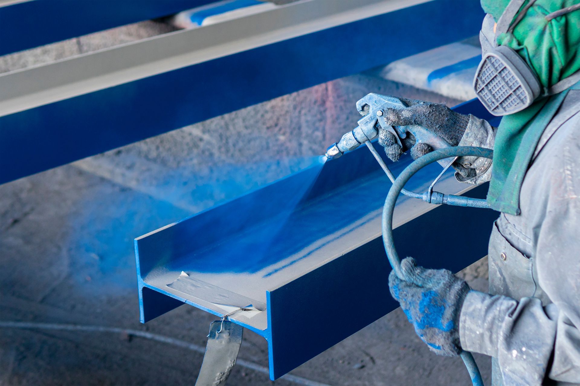 Application de peinture industrielle au pistolet sur une pièce métallique