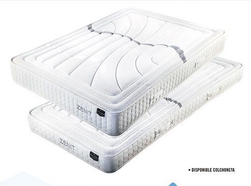 Dos colchones blancos con diseños acolchados apilados uno encima del otro, con la marca 