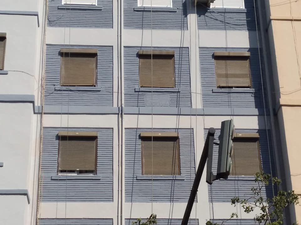 Un edificio con muchas ventanas y persianas.