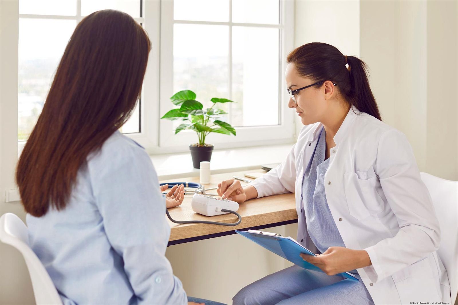 Doctor in a consultation with a patient at a desk