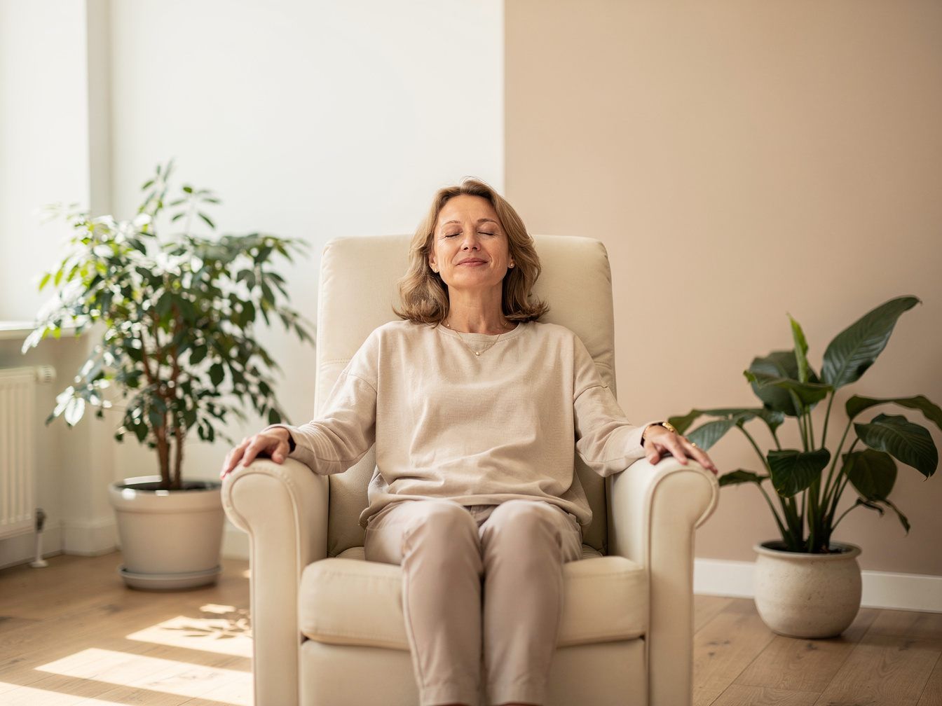 Woman sitting relaxed with her eyes closed in a treatment chair