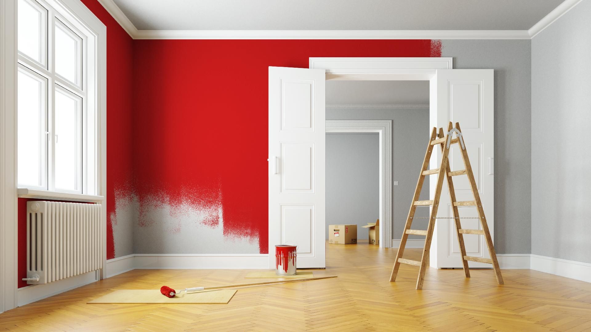Teilweise rote Wand mit Trittleiter, Farbrolle und Farbeimer auf Hartholzboden. Frischer Anstrich.