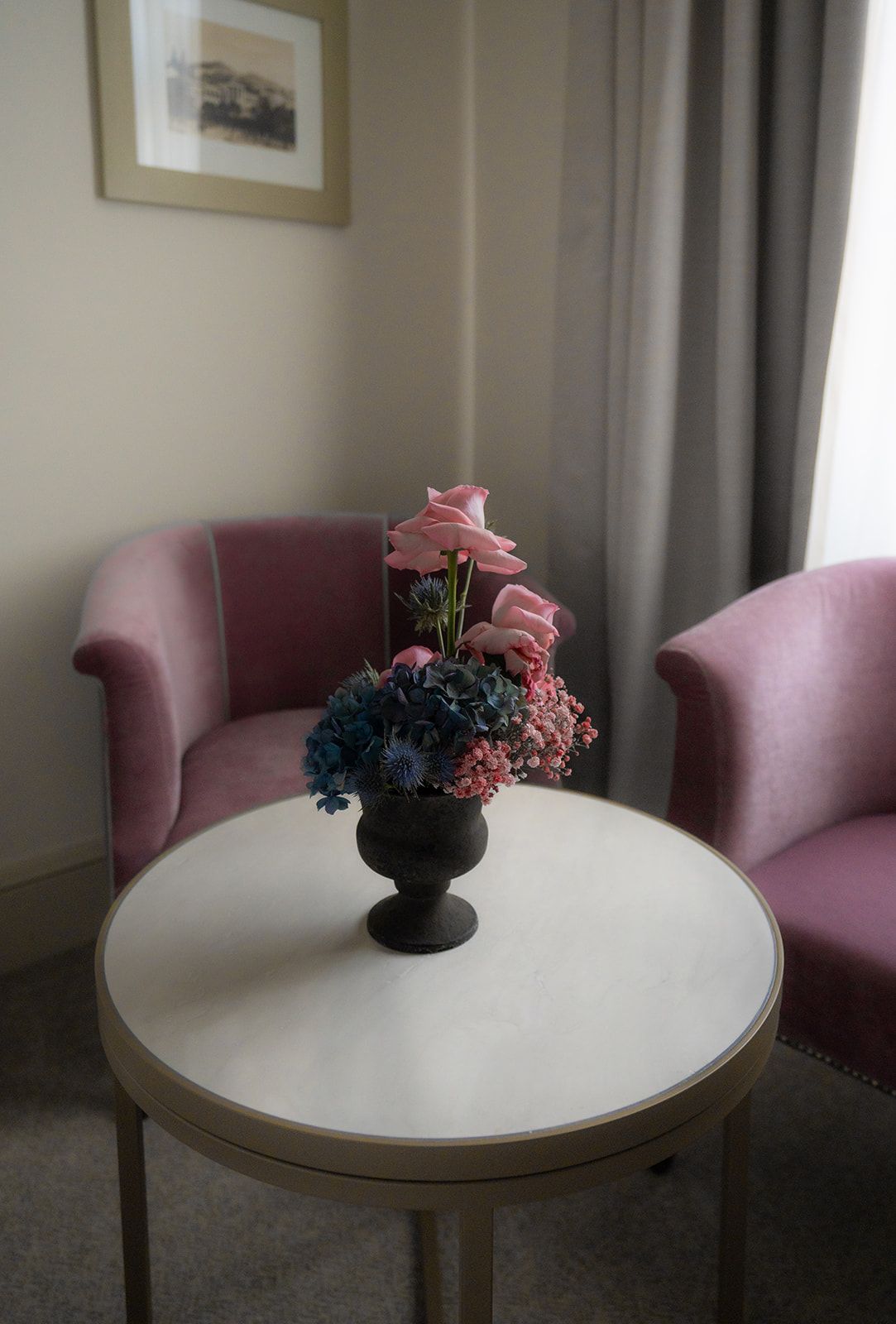 A gin cocktail served in a tall glass with citrus fruits, herbs, and ice.