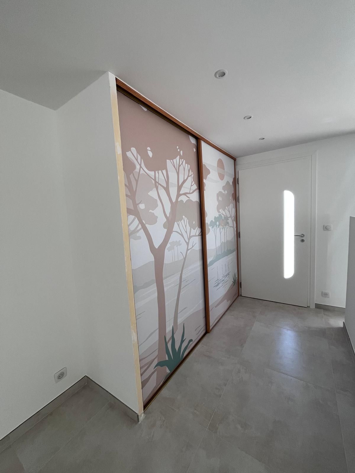 Il y a une photo d'un arbre sur le mur dans le couloir.