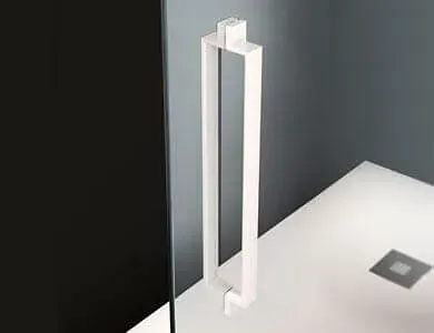 Manija rectangular blanca para puerta de ducha de cristal. Base de ducha blanca y pared gris.