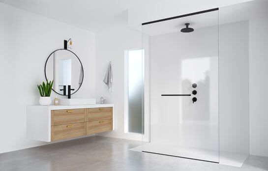 Baño blanco moderno con tocador flotante, ducha de vidrio y accesorios negros.