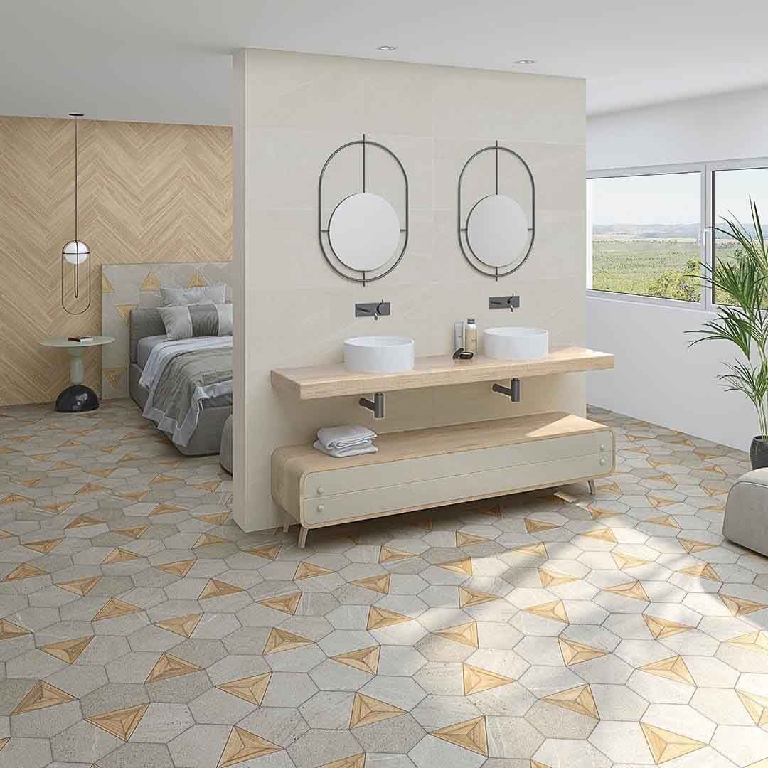 Baño con dos lavabos, cama detrás de una pared y suelo de baldosas estampadas.