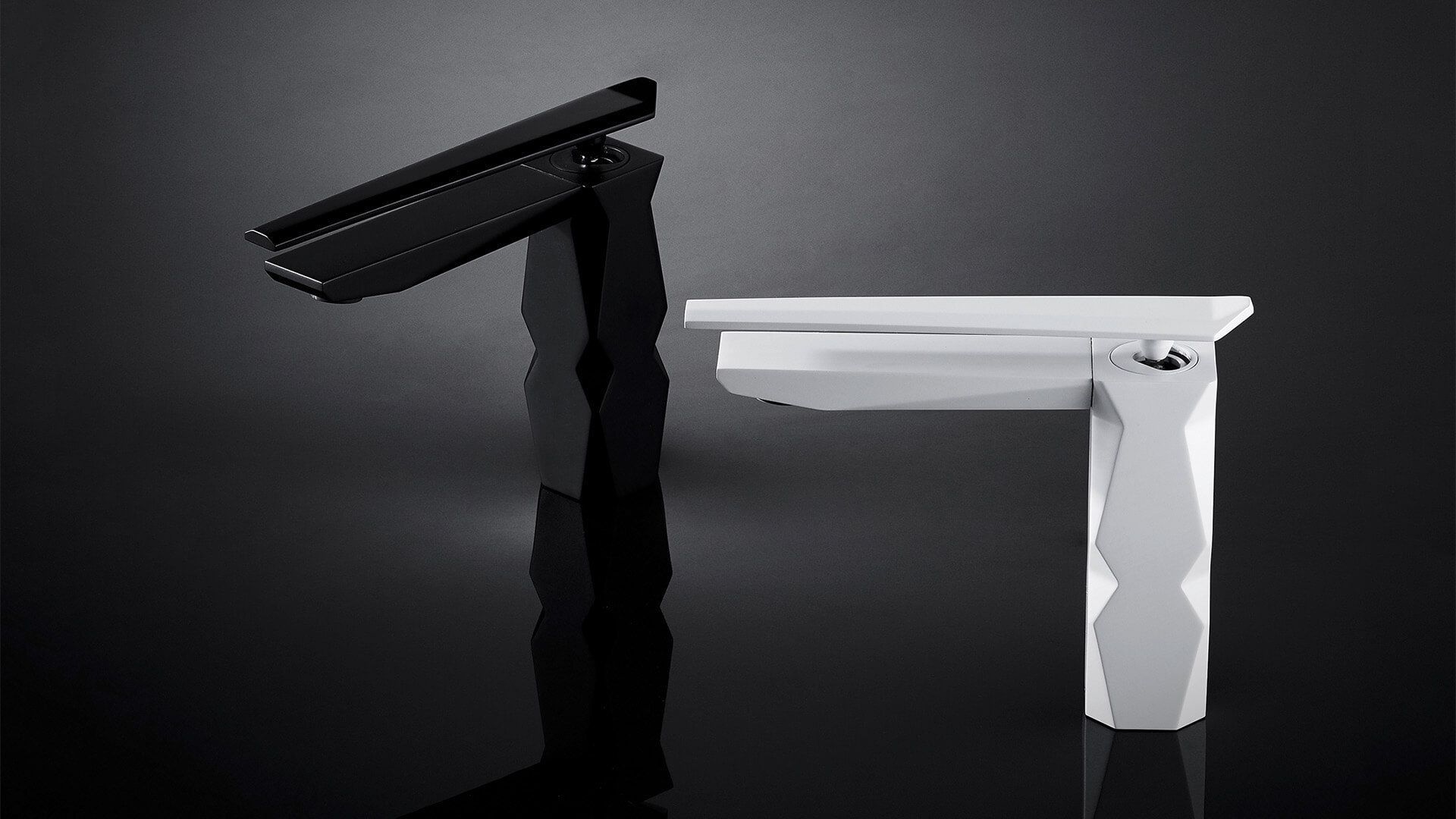 Grifos modernos en blanco y negro uno al lado del otro, en ángulo y geométricos sobre una superficie oscura.