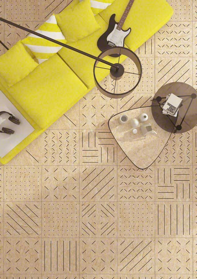 Vista aérea de una sala de estar con sofá amarillo, guitarra y piso de baldosas estampadas en tonos marrón y tostado.