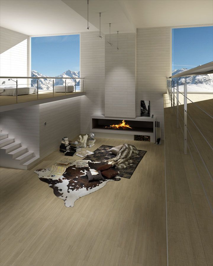 Moderna sala con chimenea, vista a la montaña, distribución de dos pisos, colores neutros.