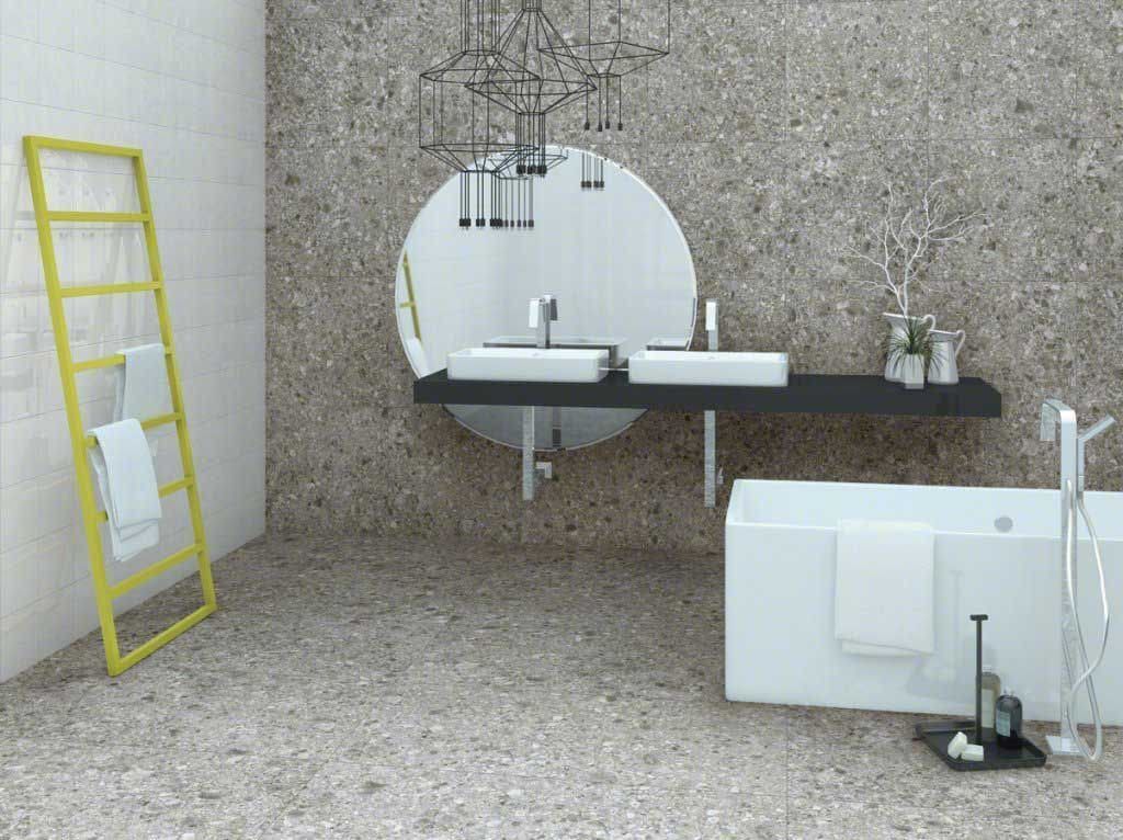 Baño moderno con bañera blanca, lavabo doble y toallero amarillo.