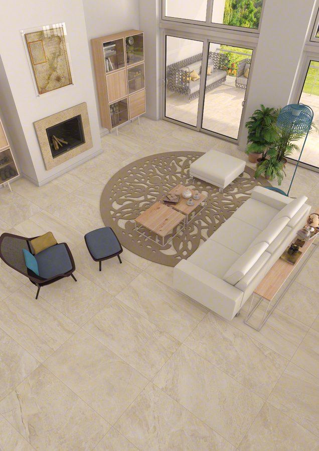 Moderna sala de estar con chimenea, sofá blanco, alfombra estampada y grandes ventanales.